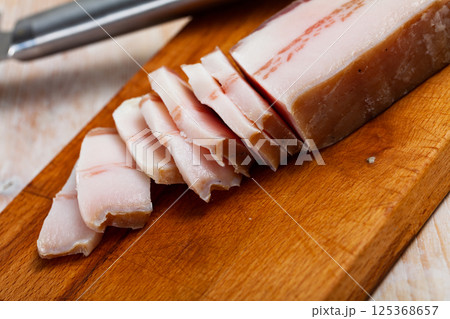 Appetizing salted pork belly on a cutting board 125368657