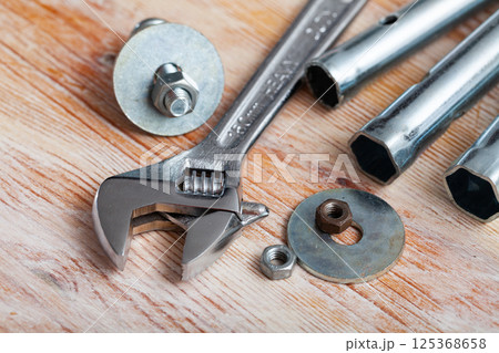 Adjustable wrench on wooden background 125368658