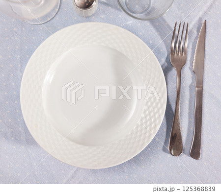 Empty plate with fork and knife Empty plate with fork and knife 125368839