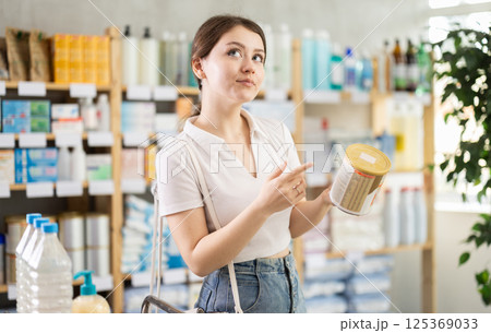 woman chooses baby food woman chooses baby food 125369033
