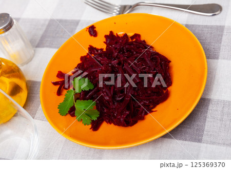 Healthy salad of shredded boiled beets with greens 125369370