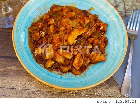 Cod stew with vegetables peppers, tomatoes, garlic and onions close-up in bowl on the table Cod stew with vegetables peppers, tomatoes, garlic and onions close-up in bowl on the table 125369521