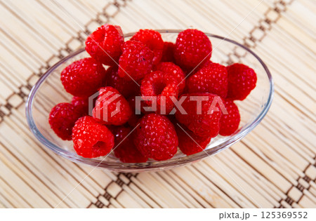 Fresh and tasty looking raspberries on table 125369552