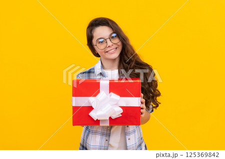 cheerful teen girl in glasses with present. studio shot of teen girl hold present. teen girl 125369842