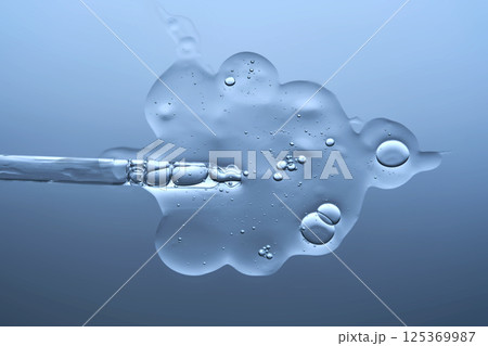 The texture of a serum with microneedles and a cosmetic pipette on a blue background. The texture of a serum with microneedles and a cosmetic pipette on a blue background. 125369987