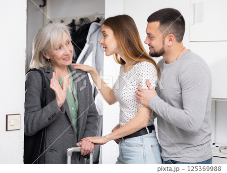 Mother visits her adult children at their home Mother visits her adult children at their home 125369988