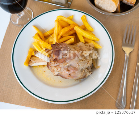 Roasted pork knuckle with vegetable garnish of fried potatoes Roasted pork knuckle with vegetable garnish of fried potatoes 125370317