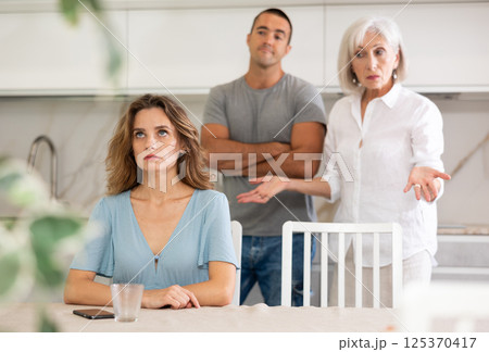Young girl with her mother-in-law and husband 125370417