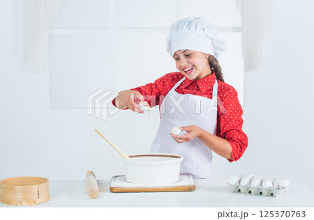 girl baking something for supper, cook girl baking something for supper, cook 125370763