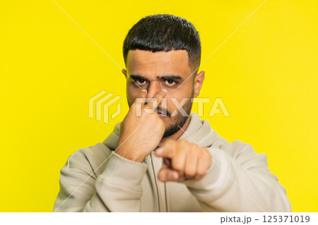 Man pointing at her eyes and camera show I am watching you gesture spying watching on someone 125371019