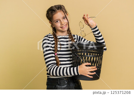 Child girl taking off throwing out glasses into bin, medical vision laser treatment therapy surgery Child girl taking off throwing out glasses into bin, medical vision laser treatment therapy surgery 125371208