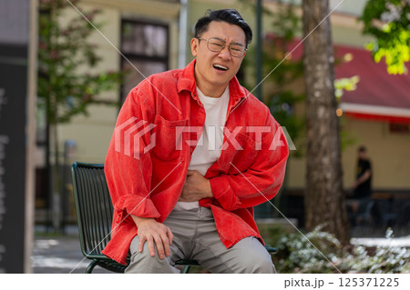 Asian middle-aged man feeling sudden strong abdominal stomach ache gastritis problem diarrhea Asian middle-aged man feeling sudden strong abdominal stomach ache gastritis problem diarrhea 125371225