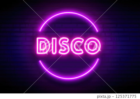 Neon Disco Sign Illuminated on Brick Wall 125371775