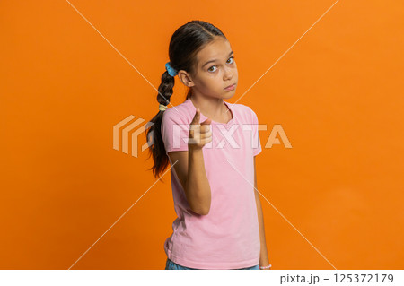 Child girl kid shakes finger and saying no, be careful, avoid danger mistake, disapproval sign Child girl kid shakes finger and saying no, be careful, avoid danger mistake, disapproval sign 125372179