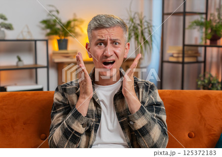 Portrait of upset Caucasian young man making face, feeling bored, disappointed in result, bad news 125372183
