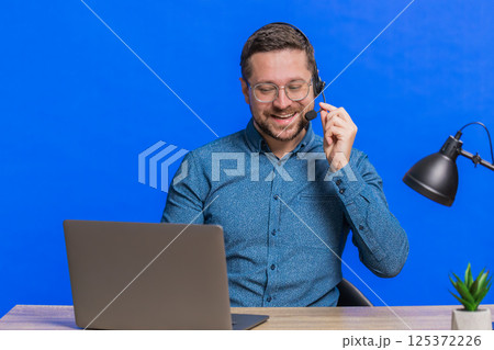 Man freelance worker call center or support service operator helpline having talk with client Man freelance worker call center or support service operator helpline having talk with client 125372226