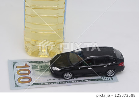 A bottle of vegetable oil and a typewriter lie on a banknote. Biodiesel, biofuel, vegetable oil,  125372389