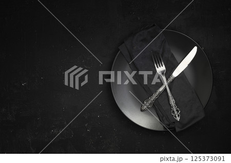 Empty black slate plate on stone table. Flatlay, top view. Mockup for restaurant dish 125373091
