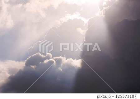A Dramatic Sky Featuring Radiant Sunlight and Beautiful Clouds in a Peaceful Atmosphere A Dramatic Sky Featuring Radiant Sunlight and Beautiful Clouds in a Peaceful Atmosphere 125373107