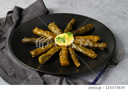 Stuffed collard greens with boiled leaves, traditonal turkish black sea region food, sarma, dolma Stuffed collard greens with boiled leaves, traditonal turkish black sea region food, sarma, dolma 125373634