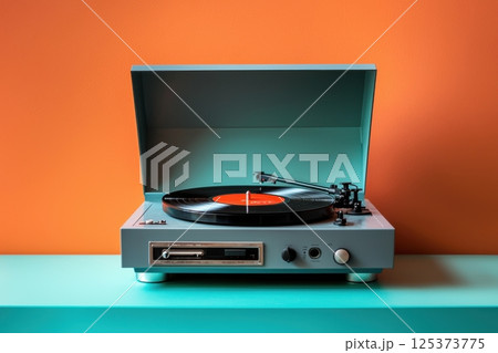 Retro vinyl record player in bold contrasting orange and blue setting Retro vinyl record player in bold contrasting orange and blue setting 125373775