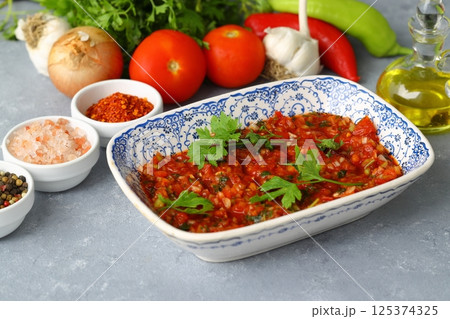 A spicy Turkish appetizer "Acili ezme" made with tomatoes, pepper, parsley, mint, olive oil A spicy Turkish appetizer "Acili ezme" made with tomatoes, pepper, parsley, mint, olive oil 125374325
