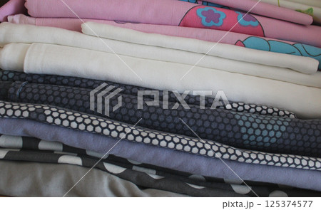 Folds Of Cozy Children Size And Colors Bedding In A Stack Closeup Stock Photo Folds Of Cozy Children Size And Colors Bedding In A Stack Closeup Stock Photo 125374577