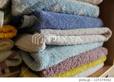 Home Wardrobe Shelf With Folded Clean Terry Towels On It  125374582