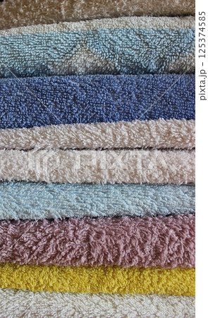 Stack of colorful folded towels closeup stock photo for vertical story  125374585