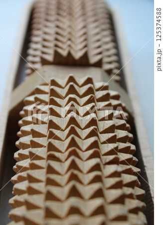 Cylindrical wooden massager extreme closeup stock photo for vertical story Cylindrical wooden massager extreme closeup stock photo for vertical story 125374588