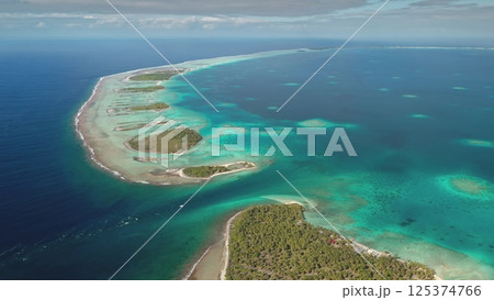 Stunning aerial perspective showcases a series of small tropical islands surrounded by vibrant turquoise waters. The scene reflects the beauty of unspoiled nature along the coastline during daylight. Stunning aerial perspective showcases a series of small tropical islands surrounded by vibrant turquoise waters. The scene reflects the beauty of unspoiled nature along the coastline during daylight. 125374766