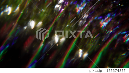 Glaring flow. Defocused luminous lines. Blue red green color flicker lens flare blurred beam motion on abstract bokeh light dark black background. Glaring flow. Defocused luminous lines. Blue red green color flicker lens flare blurred beam motion on abstract bokeh light dark black background. 125374855