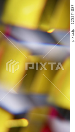 Optical shine. Blur leak flash. Defocused yellow blue red color geometric effect facet texture on abstract light background. 125374887