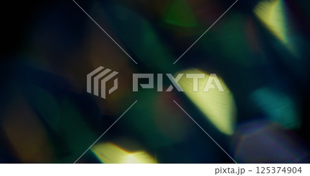 Beam leak. Blur iridescent texture. Defocused yellow green colorful rainbow spectrum light flare on abstract dark black background. 125374904