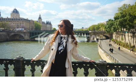Woman on Paris bridge over the Seine River Woman on Paris bridge over the Seine River 125375299