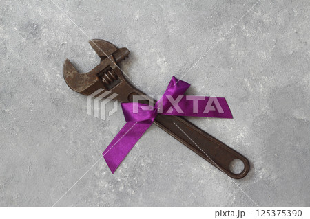 Craft gift with old tool on black background. Fathers-Labor day concept. Flat lay. Spanner gift. Craft gift with old tool on black background. Fathers-Labor day concept. Flat lay. Spanner gift. 125375390