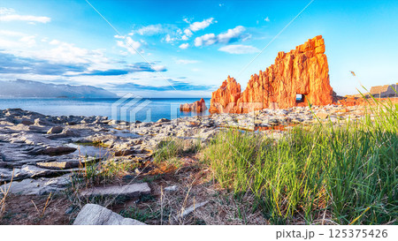 Exciting sunset view of Red Rocks (Rocce Rosse) in Arbatax. Exciting sunset view of Red Rocks (Rocce Rosse) in Arbatax. 125375426