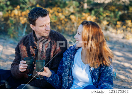 Portrait happy beautiful couple in love enjoying autumn picnic in autumn park. High quality photo Portrait happy beautiful couple in love enjoying autumn picnic in autumn park. High quality photo 125375862
