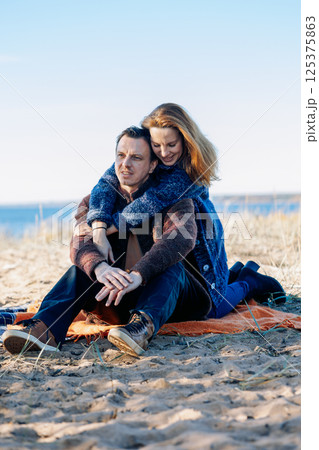 Portrait happy beautiful couple in love enjoying autumn picnic in autumn park. Vertical photo. High quality photo Portrait happy beautiful couple in love enjoying autumn picnic in autumn park. Vertical photo. High quality photo 125375863