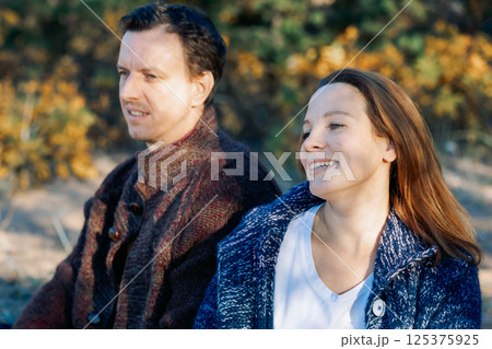 Portrait happy beautiful couple in love enjoying autumn picnic in autumn park. High quality photo Portrait happy beautiful couple in love enjoying autumn picnic in autumn park. High quality photo 125375925