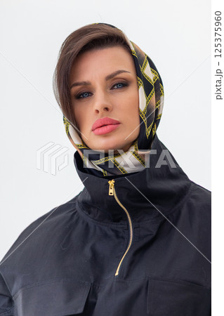 Portrait of young woman in scarf close-up on white background. Studio photography. Vertical photo. High quality photo Portrait of young woman in scarf close-up on white background. Studio photography. Vertical photo. High quality photo 125375960