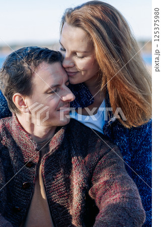 Portrait happy beautiful couple in love enjoying autumn picnic in autumn park. Vertical photo. High quality photo Portrait happy beautiful couple in love enjoying autumn picnic in autumn park. Vertical photo. High quality photo 125375980