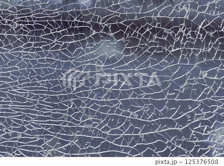 Detail of broken tempered glass pane too many small irregular shape pieces holding together. 125376508