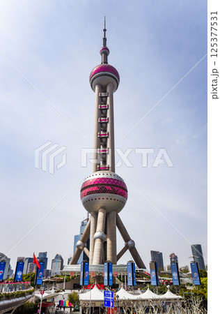 Shanghai, China - 1 April 2025: The Oriental Pearl Tower shines under clear blue skies, a futuristic landmark of Shanghai's iconic skyline 125377531