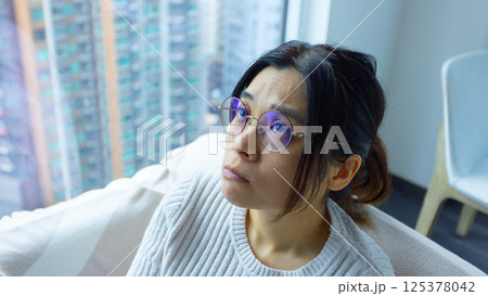 woman look up and feel stress at home, wearing the glasses woman look up and feel stress at home, wearing the glasses 125378042