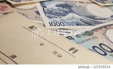 給料袋と大量の紙幣 給料袋と大量の紙幣 125378524