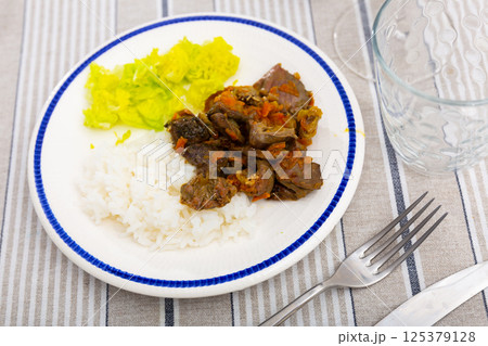 Chicken heart served with lettuce and rice 125379128