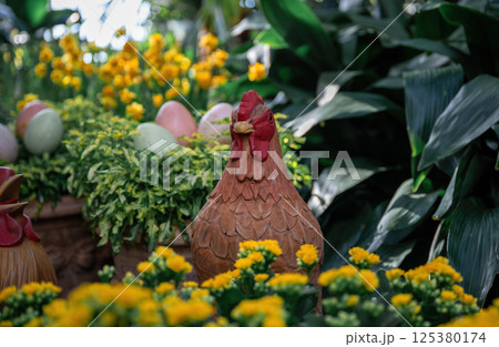 Handmade decorative chicken figure and pastel eggs in garden setting. Spring and Easter symbol Handmade decorative chicken figure and pastel eggs in garden setting. Spring and Easter symbol 125380174