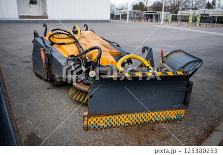street sweeper brush and plow attachments with hydraulic hoses, concept of urban maintenance tools 125380253