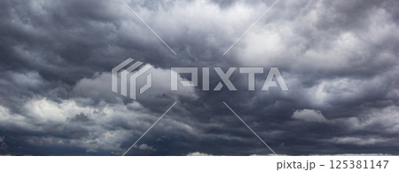 A dark and ominous sky filled with heavy clouds suggests bad weather approaching, symbolizing stormy conditions, atmospheric tension, and the unpredictable nature of the night. 125381147